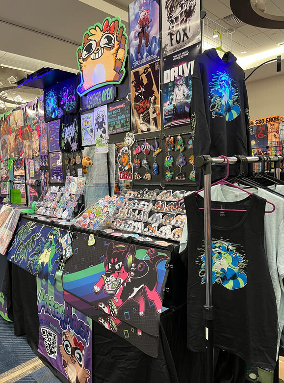 CURRENT FULL TABLE SET UP (side view w/ clothing rack; from Furlandia 2026)